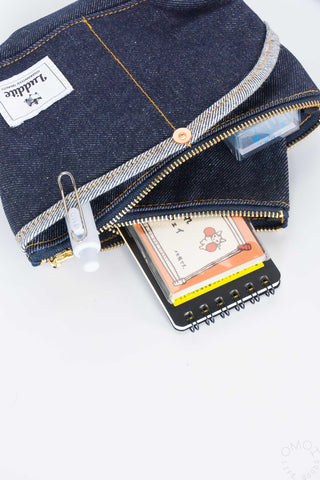 Open denim boat pouch with two zipper sections and attached keyring clip