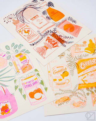 Snack-themed print with food labels in orange, pink, and blue on light paper