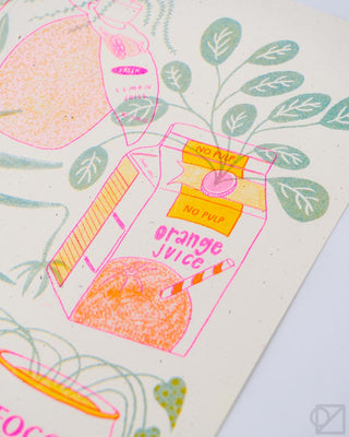 Snack-themed print with orange juice and fruit designs in pink, teal, and green
