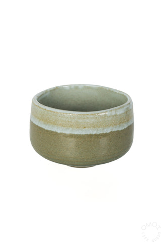 Green matcha tea bowl with light banded rim and smooth interior glaze