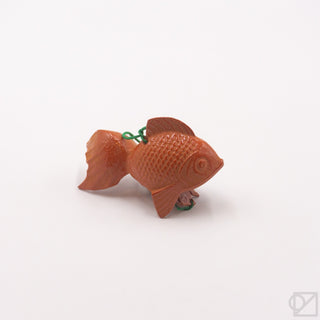 Orange fish-shaped wind chime with green hanging cord and decorative tail