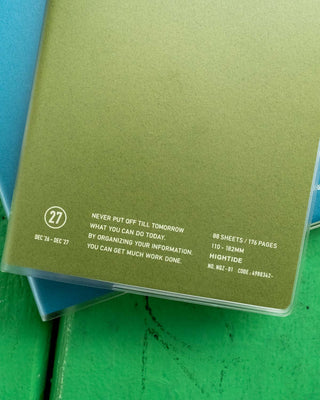 Khaki planner cover with “never put off till tomorrow” and feature details