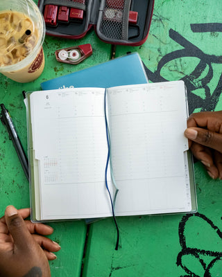 B6 slim weekly vertical planner, open to weekly calendar pages with date grids