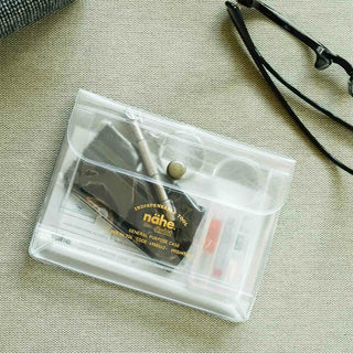 Clear general purpose case pouch with small tools inside; brass snap button on top.