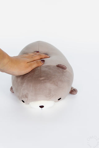Small otter hugging pillow plush, taupe-gray with white muzzle and brown ear tips