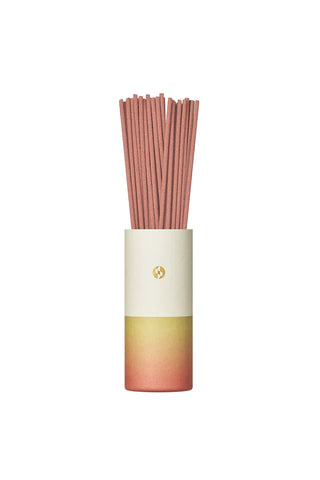 Gradient incense stick holder tube in pink-to-green with wrapped gold emblem; sticks