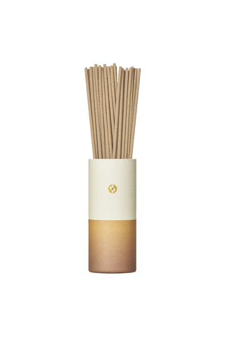 Gradient incense tube with upright wooden incense sticks and cream band label