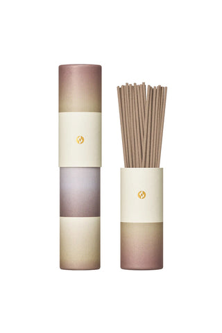 Gradient incense tube with bundled brown incense sticks in tall rose, cream, and taupe container