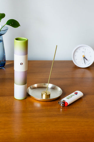 Gradient incense cylinder with incense stick in metal holder