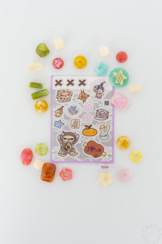 Transparent sticker sheet with colorful cutout stickers scattered around it