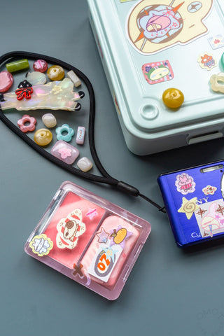 Sticker sheet assortment in clear pouch, with bunny, food icons, and small charms