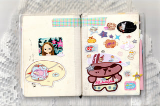 Open sticker book showing two panels of colorful cartoon character stickers