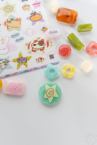Assorted small colorful stickers with hearts, stars, and cartoon character designs