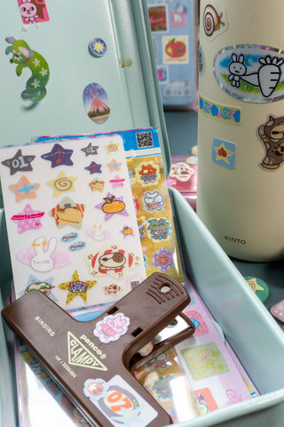 Clear organizer with sticker sheets and colorful cartoon character decals