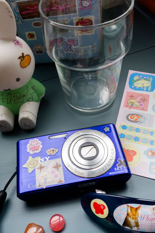 Blue sticker case with circular window and colorful character decals
