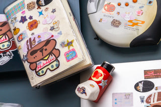 Sticker sheet with cartoon character in cap and colorful icons, plus small accessory stickers