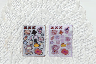 Two opaque clear sticker sheets with different cute icons in blue and purple