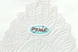 Peace! oval sticker on white mesh fabric backing