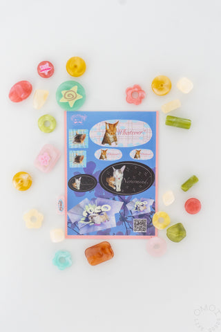 Sticker sheet centerpiece with assorted pastel pet stickers and colorful candy-like shapes