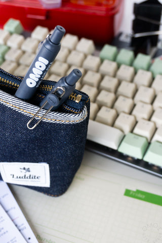 OMOI dark blue gel pen with metal clip, shown in denim pouch