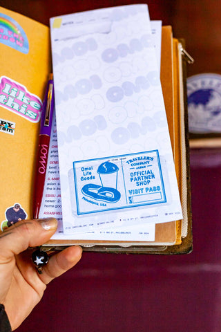 OMOI's short trips guidebook with a blue “Official Partner Shop” badge on page.