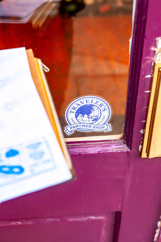 OMOI's guidebook pages beside a storefront “Partner Shop” badge.