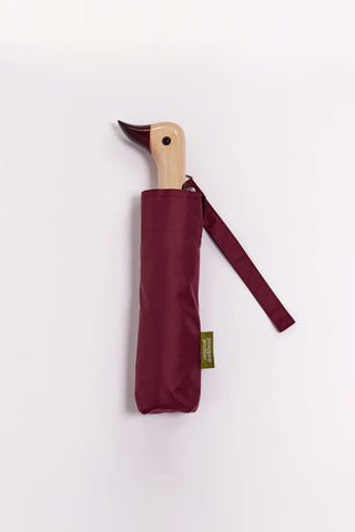 Cherry compact umbrella with duck-shaped wooden handle and maroon fabric sleeve