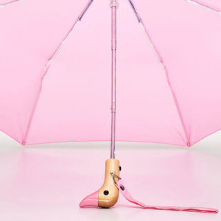 Powder pink umbrella close-up of duck handle base and clear ribs