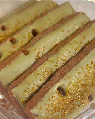 Matcha lemon shortbread cookies with green icing and golden sprinkles