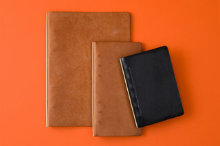 Beige leather narrow 6-ring binder with tan inner cover and black slip-in panel
