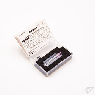 Fountain pen maintenance kit with pen cleaning tools in foam-lined open box