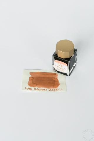 Sailor Shikiori bottled ink in a hexagonal bottle with ink color swatch card