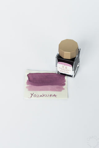 Yozakura bottled ink with mauve swatch card and clear bottle with gold cap