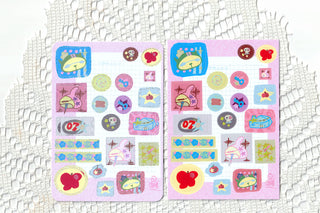 Two pink square sticker sheets with colorful cartoon character and item icons