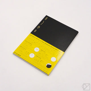 STÁLOGY 018 grid editor's notebook with black cover and yellow label
