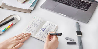 Open grid notebook with handwritten notes in a black-ink layout