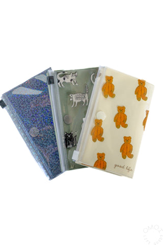 Set of small zip pouches with holographic and animal-print covers, chain pulls