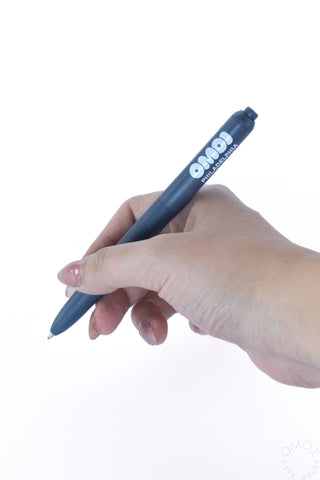 Hand holding a blue gel pen with tip poised to write