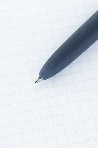 Dark blue gel pen with fine tip on grid notebook paper