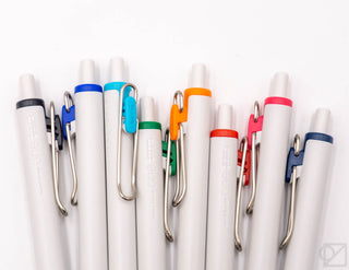 Set of eight Uni-Ball One gel pens with white barrels and colored end caps, close-up