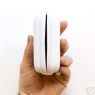 White mini stationery kit case with zip closure, held in hand