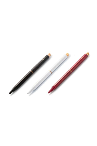 Portable ballpoint pen set with black, white, and red barrels and gold accents