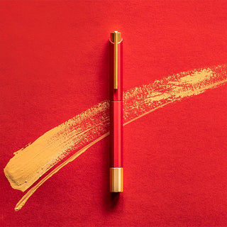 Red rollerball pen with gold cap and barrel accents