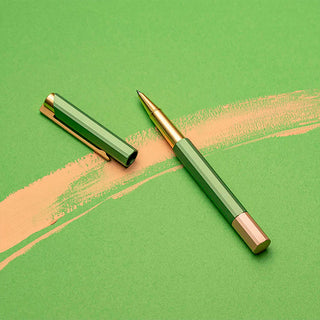 Green rollerball pen with gold details and transparent grip