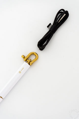 White ballpoint pen with gold keyring loop and black cord