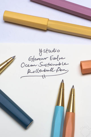 Light blue rollerball pen with gold tip and matching cap, with second pen nearby