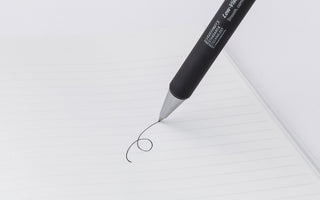 STÁLOGY 015 black ballpoint pen with 0.7mm tip writing on lined paper