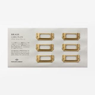 Brass label plate set with six rectangular blank nameplate frames on card backing