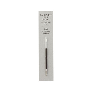 Ballpoint pen refill with dark barrel and white cap in a retail sleeve