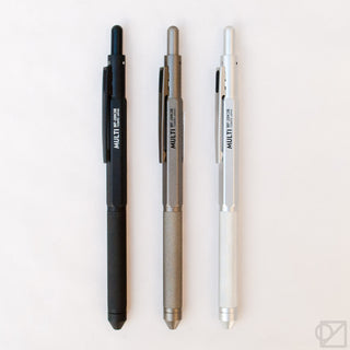 Three OHTO multi-pen bodies: matte black, gunmetal gray, and white with textured grip